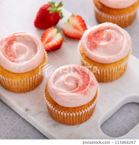 Strawberry lemonade cupcakes with a swirl of cream cheese frosting 113868267