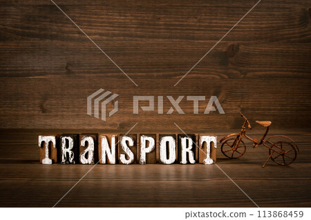 TRANSPORT. Text from alphabet blocks and rusty miniature bicycle on wood texture background 113868459
