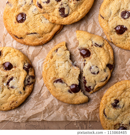 Chocolate chip cookies with flaky salt on parchment paper Chocolate chip cookies with flaky salt on parchment paper 113868485