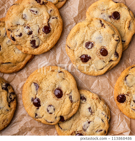 Chocolate chip cookies with flaky salt on parchment paper Chocolate chip cookies with flaky salt on parchment paper 113868486