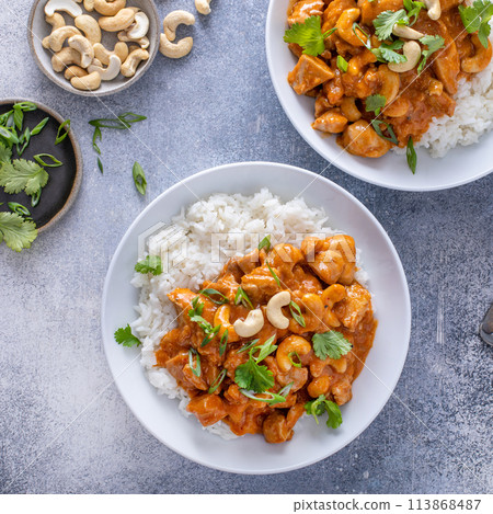 Traditional thai chicken curry with cashews and herbs Traditional thai chicken curry with cashews and herbs 113868487