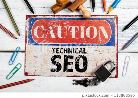 Technical SEO. Metal CAOTION plate with text on a white wooden background Technical SEO. Metal CAOTION plate with text on a white wooden background 113868580
