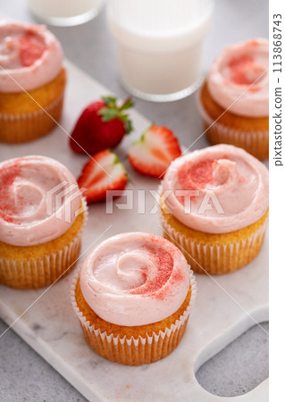 Strawberry lemonade cupcakes with a swirl of cream cheese frosting 113868743
