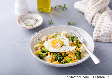 Healthy breakfast bowl with cooked vegetables and fried egg 113868784