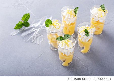 Lemon curd layered dessert shots for a party Lemon curd layered dessert shots for a party 113868803
