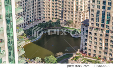 Manmade lake and residential buildings in Greens neighborhood timelapse in Dubai, UAE Manmade lake and residential buildings in Greens neighborhood timelapse in Dubai, UAE 113868890