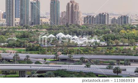 Dubai Golf Course with a cityscape of Greens and tecom districts at the background aerial timelapse 113868919