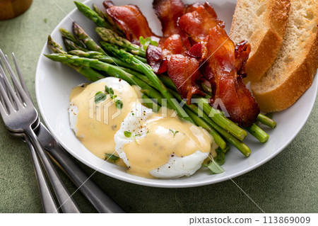 Healthy breakfast with poached eggs, bacon and asparagus Healthy breakfast with poached eggs, bacon and asparagus 113869009