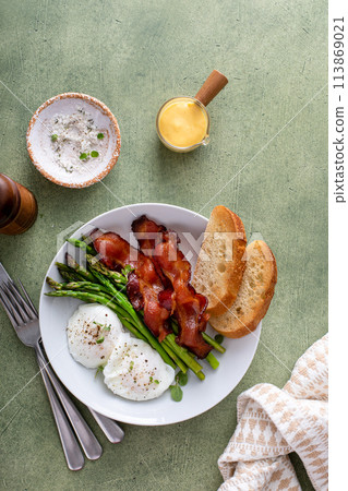 Healthy breakfast with poached eggs, bacon and asparagus Healthy breakfast with poached eggs, bacon and asparagus 113869021