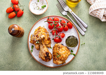 Roasted lemon and herb chicken drumsticks and thighs 113869049