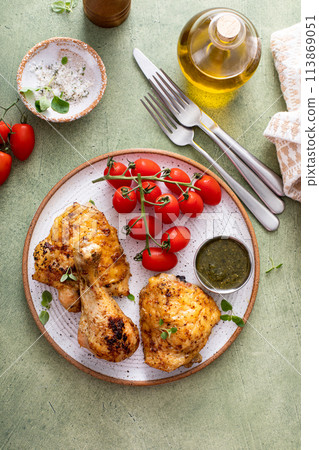 Roasted lemon and herb chicken drumsticks and thighs Roasted lemon and herb chicken drumsticks and thighs 113869051