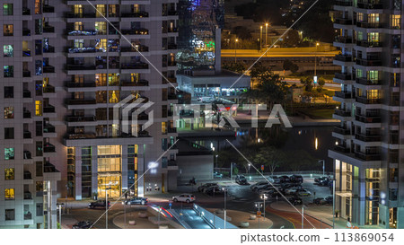 Traffic at parking near entrance to skyscrapers in Jumeirah Lakes Towers night timelapse. Traffic at parking near entrance to skyscrapers in Jumeirah Lakes Towers night timelapse. 113869054