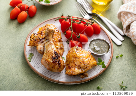 Roasted lemon and herb chicken drumsticks and thighs 113869059