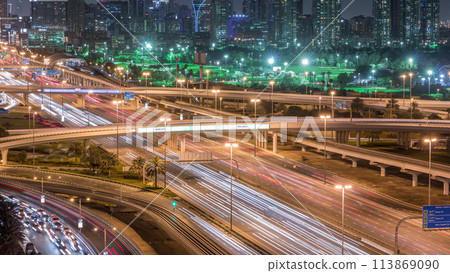Dubai Golf Course with a cityscape of Greens and tecom districts at the background aerial night timelapse 113869090