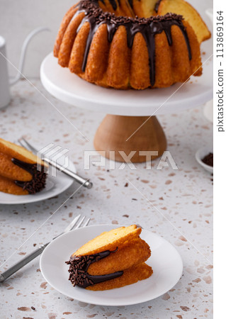 Orange pound cake with dark chocolate ganache and sprinkles Orange pound cake with dark chocolate ganache and sprinkles 113869164