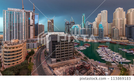 Luxury yachts parked on the pier in Dubai Marina bay with city aerial view timelapse Luxury yachts parked on the pier in Dubai Marina bay with city aerial view timelapse 113869183