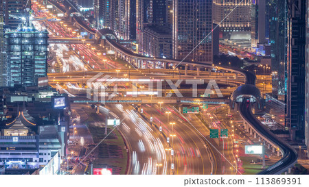 Night traffic on a busy intersection on Sheikh Zayed road highway aerial timelapse. Night traffic on a busy intersection on Sheikh Zayed road highway aerial timelapse. 113869391