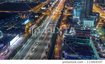 Aerial view to traffic on Sheikh Zayed road and skyscrapers on Dubai downtown night timelapse, Dubai, United Arab Emirates Aerial view to traffic on Sheikh Zayed road and skyscrapers on Dubai downtown night timelapse, Dubai, United Arab Emirates 113869397