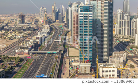 Skyscrapers on Sheikh Zayed Road and DIFC aerial timelapse in Dubai, UAE. 113869405