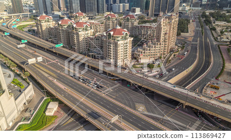 Aerial view of highway interchange in Dubai downtown morning timelapse. 113869427