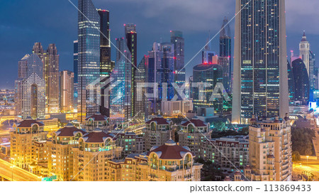 Skyline view of the buildings of Sheikh Zayed Road and DIFC night to day timelapse in Dubai, UAE. 113869433
