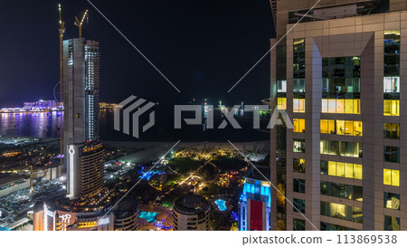 Aerial view of modern skyscrapers and beach at Jumeirah Beach Residence JBR night timelapse in Dubai, UAE 113869538