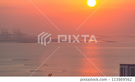 Sunset over Bluewaters island aerial timelapse 113869562