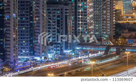 Aerial view of Dubai Tram in Dubai marina night timelapse. 113869607