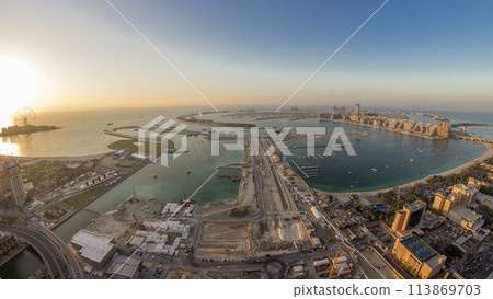 Aerial sunset view of Palm Jumeirah Island day to night timelapse. 113869703