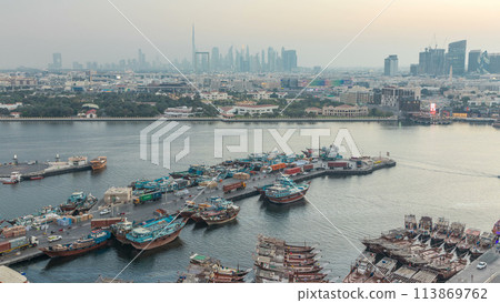 Dubai creek landscape day to night timelapse with boats and ship near waterfront Dubai creek landscape day to night timelapse with boats and ship near waterfront 113869762