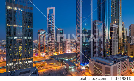 Skyline view of the buildings of Sheikh Zayed Road and DIFC day to night timelapse in Dubai, UAE. Skyline view of the buildings of Sheikh Zayed Road and DIFC day to night timelapse in Dubai, UAE. 113869818