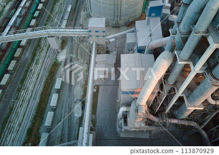 Cement plant with high factory structure and tower cranes at industrial production area. Manufacture and global industry concept Cement plant with high factory structure and tower cranes at industrial production area. Manufacture and global industry concept 113870929