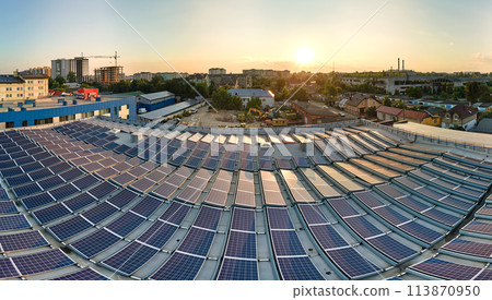 Blue photovoltaic solar panels mounted on building roof for producing clean ecological electricity at sunset. Production of renewable energy concept 113870950