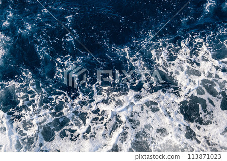 Top down aerial view of sea water surface. White foam waves texture as natural background. 113871023