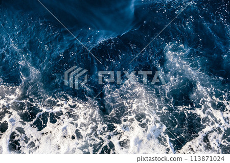Top down aerial view of sea water surface. White foam waves texture as natural background. Top down aerial view of sea water surface. White foam waves texture as natural background. 113871024