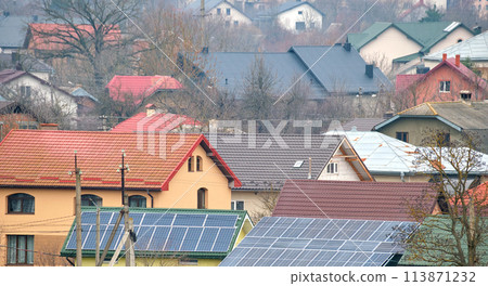 Residential house with rooftop covered with solar photovoltaic panels for producing of clean ecological electrical energy in suburban rural area. Concept of autonomous home 113871232