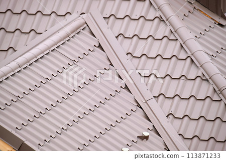 Closeup of house roof top covered with metallic shingles 113871233
