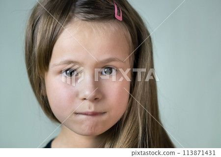 Close up portrait of little child girl with funny face expression. 113871431