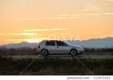 Car driving fast on intercity road at sunset. Highway traffic in evening 113871810