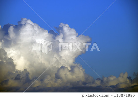 White fluffy cumulonimbus clouds forming before thunderstorm on summer blue sky. Changing stormy cloudscape weather 113871980