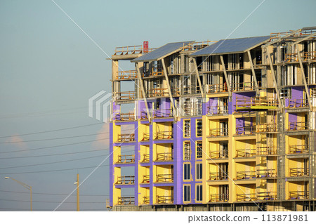 Tower cranes and frame structure of high residential apartment buildings at construction site. Real estate development 113871981