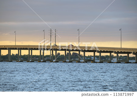Barron Collier Bridge and Gilchrist Bridge in Florida with moving traffic. Transportation infrastructure in Charlotte County connecting Punta Gorda and Port Charlotte over Peace River 113871997
