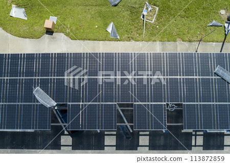 Destroyed by hurricane wind photovoltaic solar panels mounted on carport roof for producing green ecological electricity for electric vehicle charging. Consequences of natural disaster in Florida Destroyed by hurricane wind photovoltaic solar panels mounted on carport roof for producing green ecological electricity for electric vehicle charging. Consequences of natural disaster in Florida 113872859