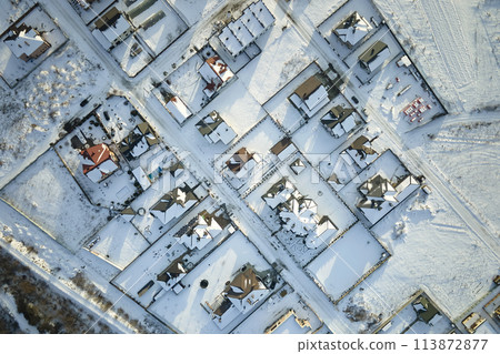 Aerial view of residential houses with snow covered roofops in suburban rural town area in winter 113872877