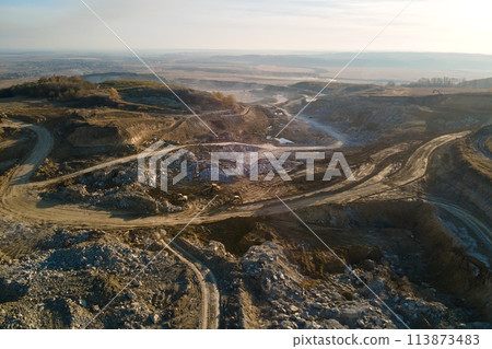 Aerial view of open pit mine of sandstone materials for construction industry with excavators and dump trucks. Heavy equipment in mining and production of useful minerals concept Aerial view of open pit mine of sandstone materials for construction industry with excavators and dump trucks. Heavy equipment in mining and production of useful minerals concept 113873483