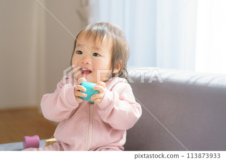 Baby with a toy 113873933