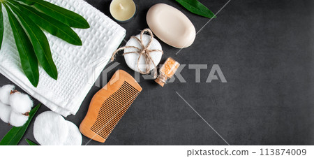 Wellness and spa accessories on dark concrete background. Towel, hairbrush, candles and soap. Wellness and spa accessories on dark concrete background. Towel, hairbrush, candles and soap. 113874009