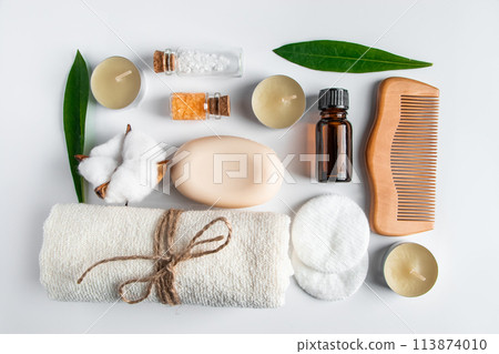 Set of natural cosmetics and spa accessories on white background. Towel, soap, hairbrush, essential oil. Set of natural cosmetics and spa accessories on white background. Towel, soap, hairbrush, essential oil. 113874010