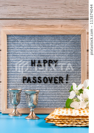 Happy Passover. Metal wine glasses and traditional Jewish matzo bread. Happy Passover. Metal wine glasses and traditional Jewish matzo bread. 113874044