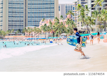 Man running towards the ocean on Waikiki Beach, Hawaii Man running towards the ocean on Waikiki Beach, Hawaii 113874054